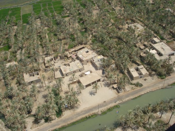 View of a village built up around a irrigation ditch.