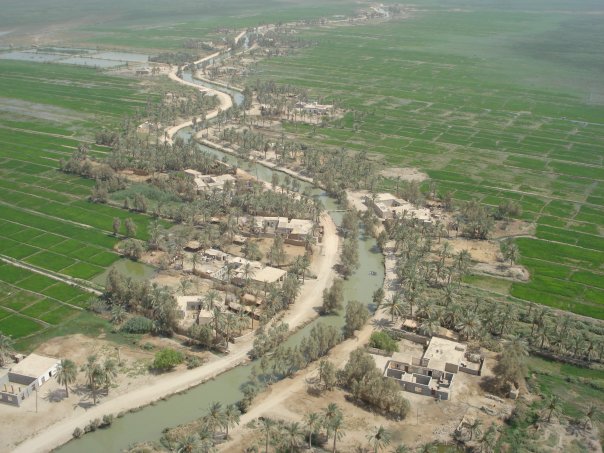View of a village built up around a irrigation ditch.